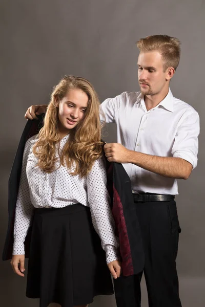 Young man giving his jacket to his girl — Stock Photo, Image