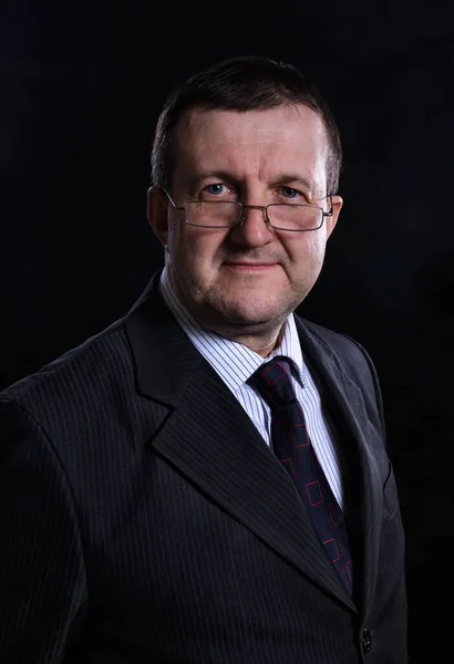 Middle aged solid man dressed in suit studio portrait