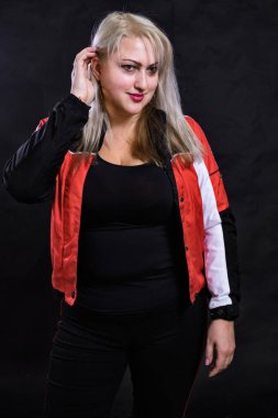 Spor tarzı giyinmiş çekici, tombul bir kadın.