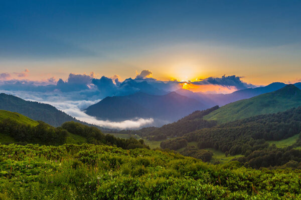 Beautiful mountain landscape at Caucasus mountains with clouds and blue sky