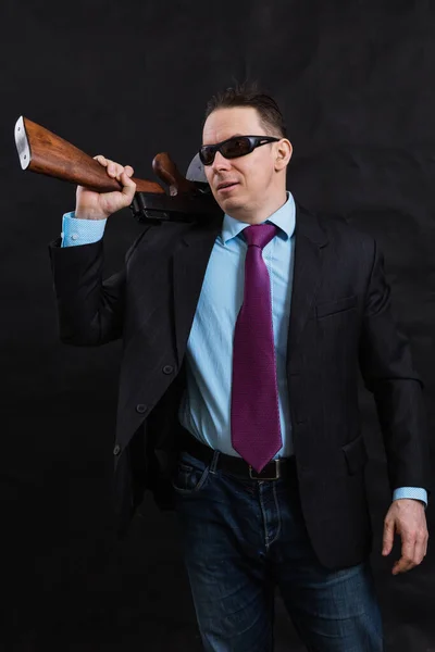 Volwassen gangster in zonnebril gekleed in pak met tommy gun — Stockfoto