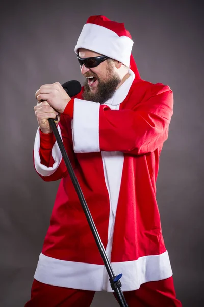 Γενειάδα rock με micriphome ντυμένος με κοστούμι Άγιος Βασίλης — Φωτογραφία Αρχείου
