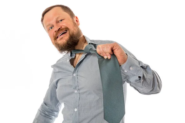 Веселий бородатий чоловік, одягнений у сорочку, зриває краватку — стокове фото
