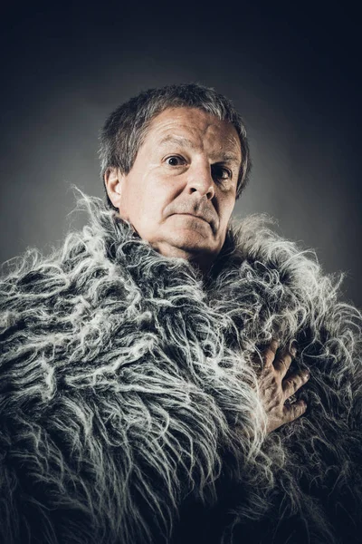 Solid middle-aged man in a fur mantle