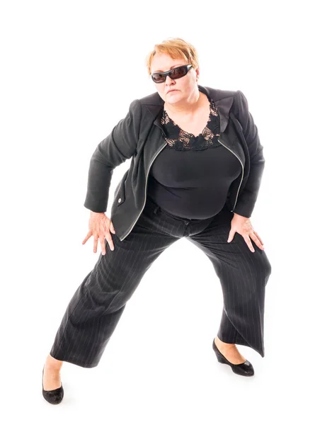 Middle aged woman in black jacket and trousers dancing an emotional dance — Stock Photo, Image