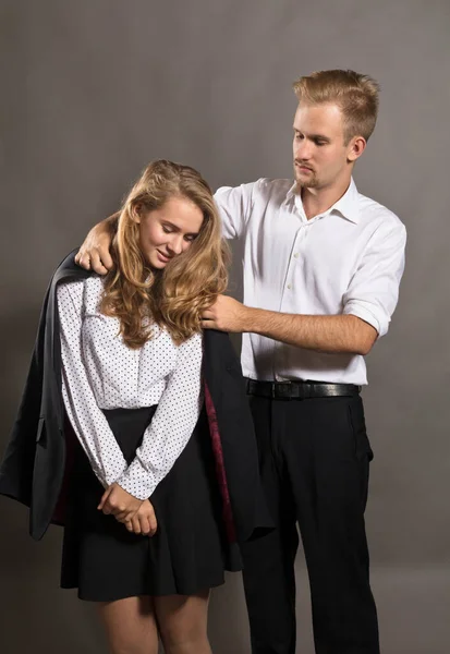 Young man giving his jacket to his girl — Stock Photo, Image