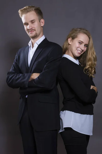 Young beautiful couple studio portrait on grey background. — Stock Photo, Image