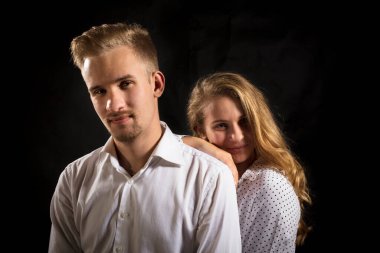 Siyah arka planda genç ve güzel bir çift..