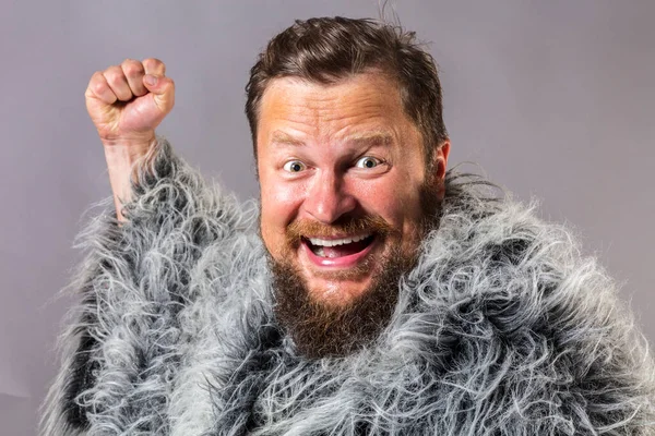 Solid bearded man in a fur mantle studio emotional