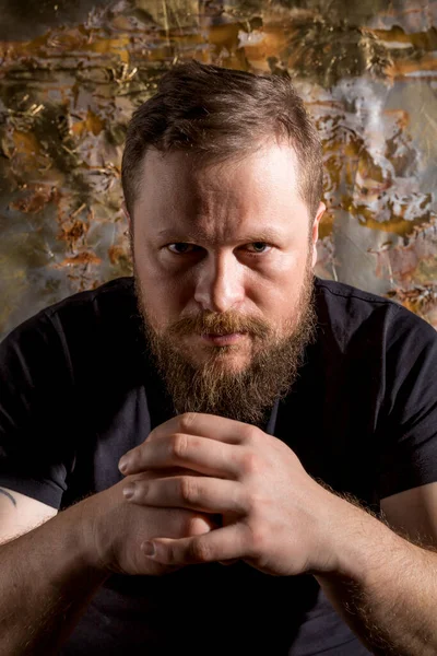 Mature bearded man in t-shirt emotional studio portrait.. Royalty Free Stock Images