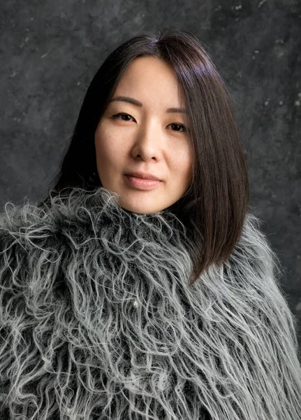 Beautiful korean woman dressed in fur mantle