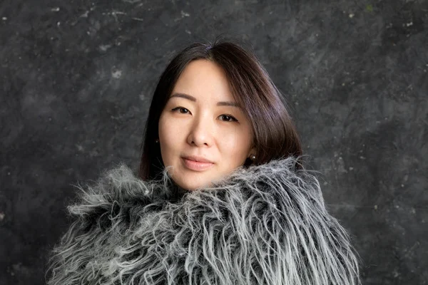 Beautiful korean woman dressed in fur mantle