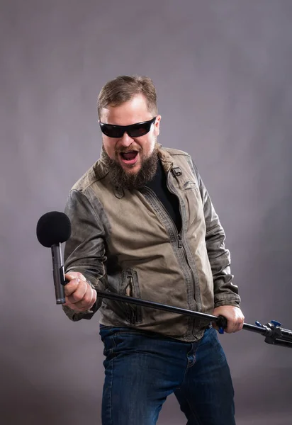 Cantor de rock emocional barbudo com retrato de estúdio de microfone. — Fotografia de Stock