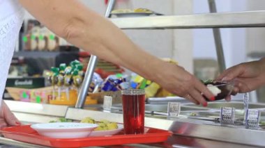 Woman taking the meal on the tray