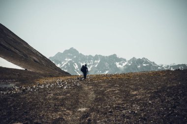 Kafkasya dağlarında yürüyüş yapan turistlerle dolu güzel bir dağ manzarası.