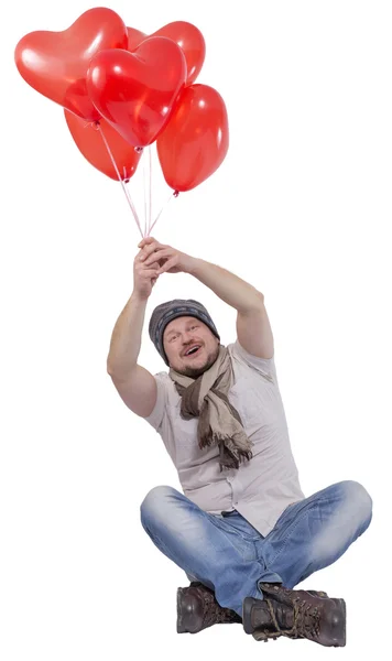 Junger Mann fliegt auf Luftballons auf weißem Hintergrund — Stockfoto
