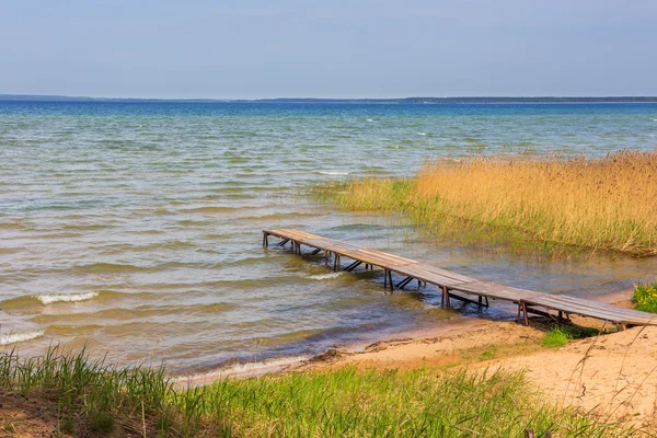 River shore with wooden pier — Stock Photo, Image