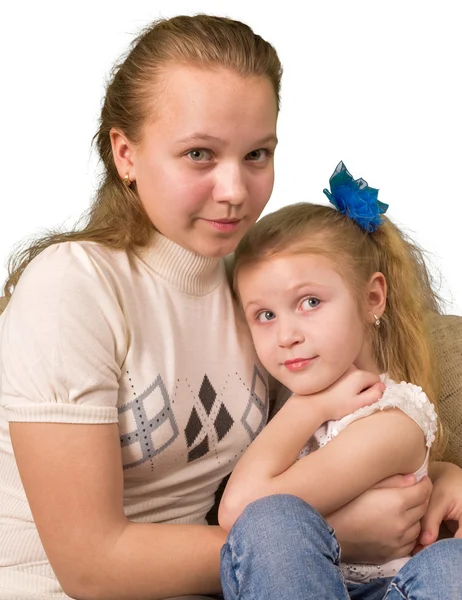 Twee zussen zitten samen geïsoleerd op witte achtergrond — Stockfoto