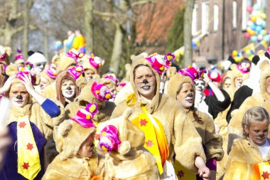 OLDENZAAL, NETHERLANDS - MARCH 6, 2011: People in colourful carnival dress during the annual carnival parade  in Oldenzaal, Netherlands.