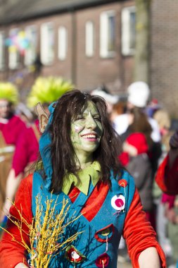 OLDENZAAL, NETHERLANDS - MARCH 6, 2011: People in colourful carnival dress during the annual carnival parade  in Oldenzaal, Netherlands.