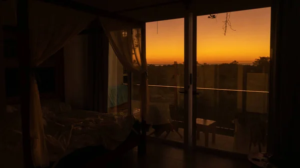 Early sunrise through panoramic windows. Warm and beautiful awakening.