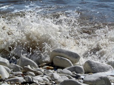 Küçük dalgalar sahile üstünde-e doğru gürültüyle çarpmak