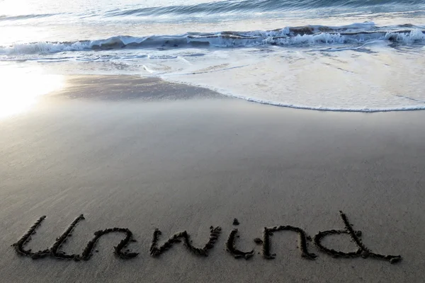 Yaklaşan dalgaları ile kuma yazılı gevşeyin