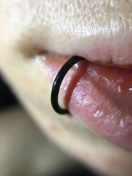 Fresh lips piercing closeup view