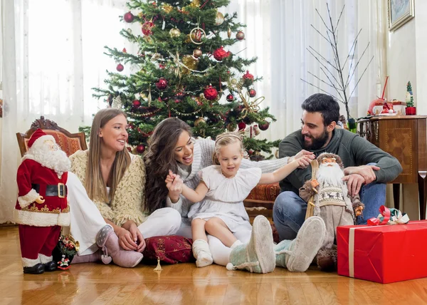 Happy family in front of Christmas tree — Stock Photo, Image