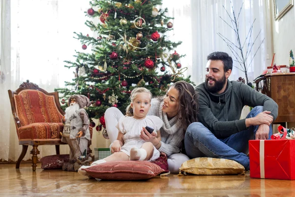Família feliz na frente da árvore de Natal — Fotografia de Stock