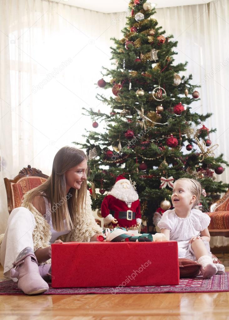 Mother and daughter opening presents