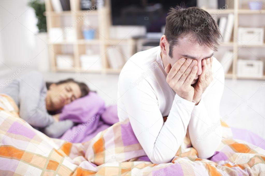 Man Awake In Bed Suffering With Insomnia