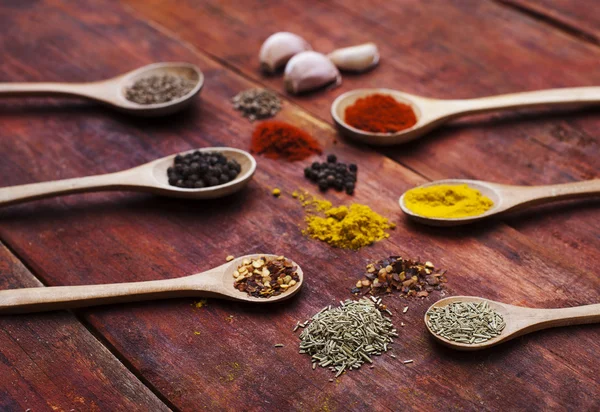 Colorful spices on wooden board — Stock Photo, Image