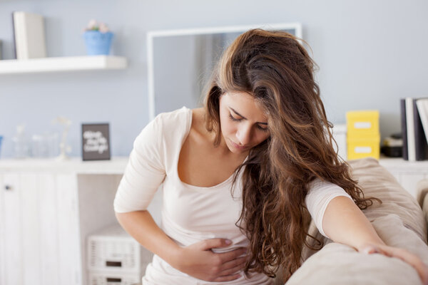 woman with hard stomach pain