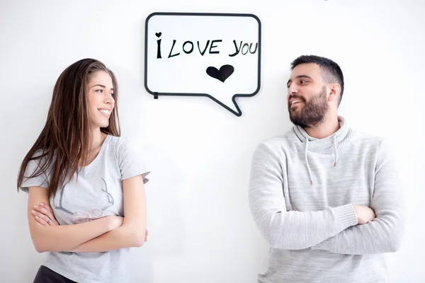 Pareja joven mostrando mensaje de amor escrito en pizarra blanca. Te amo mensaje . —  Fotos de Stock