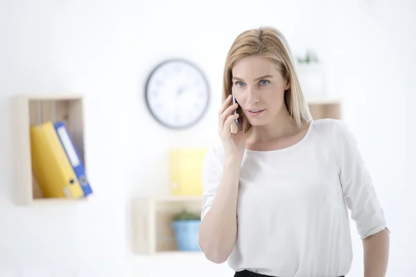 Kobieta w biurze rozmawiając na telefon — Zdjęcie stockowe