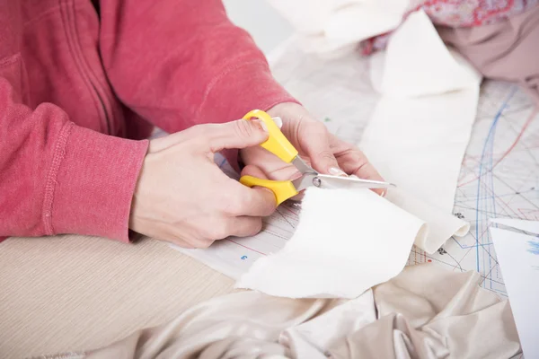 Taylor stříhání látky pomocí scissor.cutting tkanina s taylor nůžky — Stock fotografie