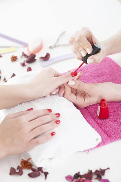 Woman applying red nail — Stock Photo, Image