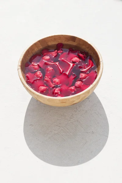 Red rose petals in bowl — Stock Photo, Image