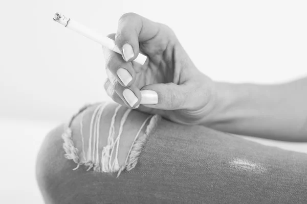 The woman hand is holding cigarette on white background. — Stock Photo, Image