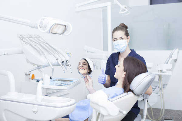 Beautiful woman patient having dental treatment at dentist's office