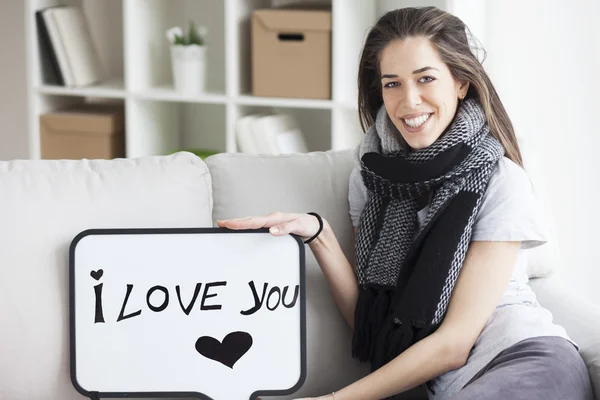 Woman holding white board with 'I love you' — Stockfoto