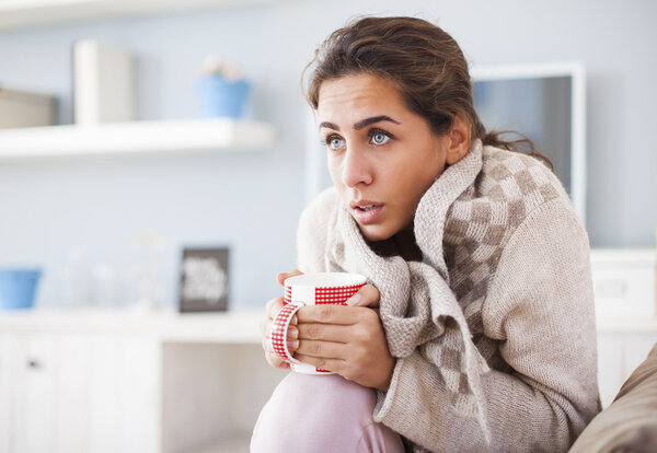 Sick woman drinking tea