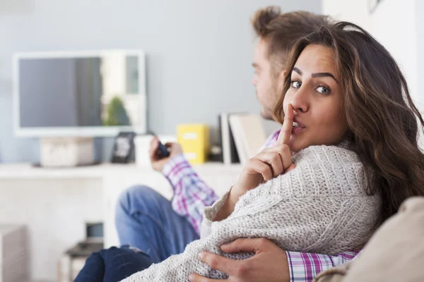 couple in living room watching tv