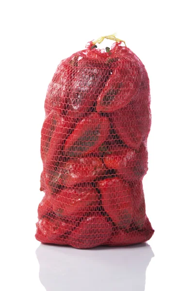 Red peppers in a sack bag — Stock Photo, Image