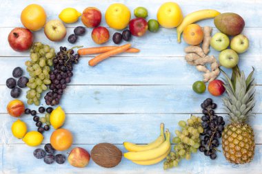 Fruits on a blue wooden board, top view clipart