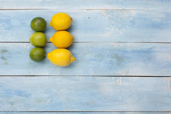 Zitrusfrüchte auf einem alten blauen Holzbrett — Stockfoto