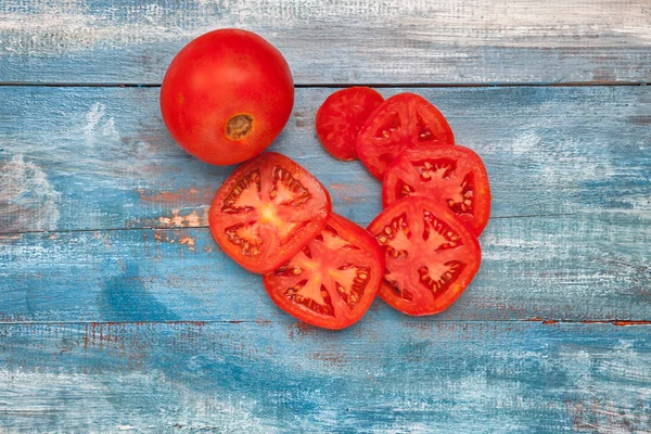 Gesneden tomaten op een houten plank — Stockfoto
