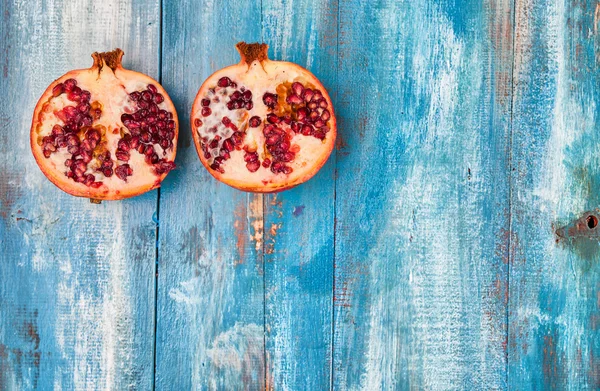 Pomegranate on vintege blue background — Stock Photo, Image