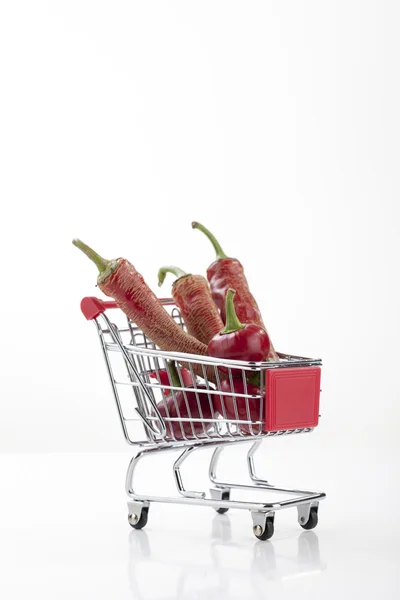 Red hot chili peppers in supermarket trolley — Stock Photo, Image